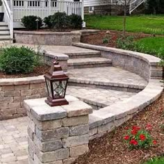 an outdoor patio with stone steps and landscaping