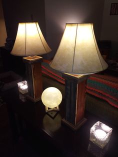 two lamps sitting on top of a table next to each other