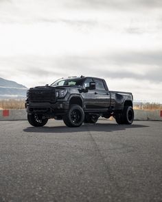 a black truck is parked on the road