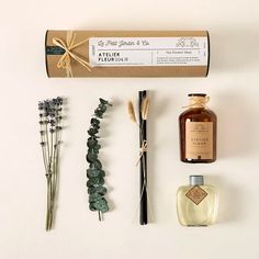 the contents of an assortment of items displayed on a white surface, including reeds and flowers