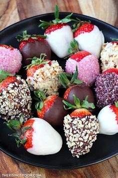 chocolate covered strawberries on a plate with sprinkles and other toppings