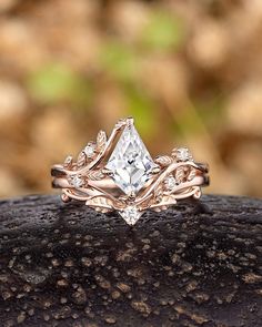 a close up of a wedding ring on top of a rock