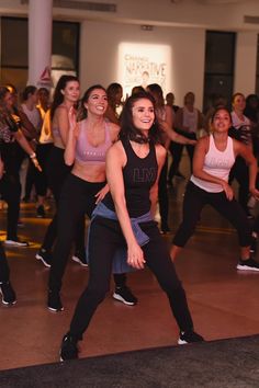 a group of women are dancing in a dance class