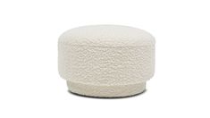 a white poufce ottoman sitting on top of a white floor