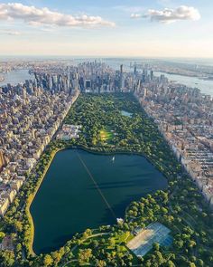 an aerial view of the central park in new york city, with lake and skyscrapers