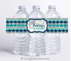 three water bottles with labels on them sitting in front of each other, one is empty