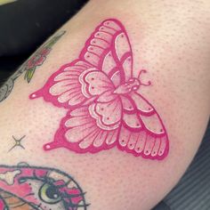 a close up of a person's legs with tattoos on them and a pink butterfly