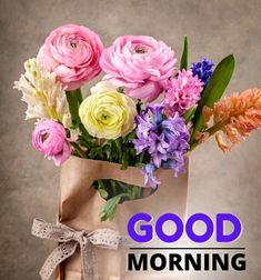 a bouquet of flowers in a paper bag with the words good morning on it,