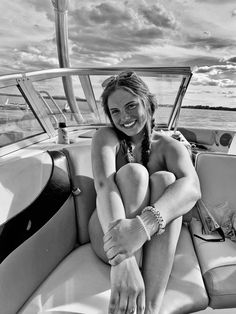 a woman sitting on the back of a boat