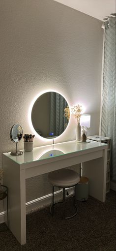 there is a vanity with a lighted mirror on it