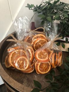 orange slices wrapped in plastic on a wooden table