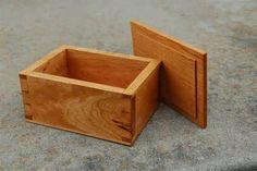 two small wooden boxes sitting on the ground