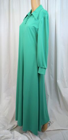 "Vintage 1970s mint green evening gown, formal, floor length dress, maxi from Leslie Fay Knits. Fabric is a lightweight polyester knit. A line cut with center front and back seams. Long sleeves finish in a cuff that buttons with a self covered button. Exaggerated pointed collar on a slight V neckline that buttons. (Since being photographed the loose button has been sewn back on and the very top button moved to replace the second from top missing button). Double top stitching accents the edge of Modest Green V-neck Maxi Dress, Vintage Green Maxi Dress For Evening, Vintage Green Evening Maxi Dress, Green Formal Maxi Dress, Green Evening Gowns, Vintage Clothing Online, Evening Gowns Formal, Floor Length Dresses, Dress Maxi