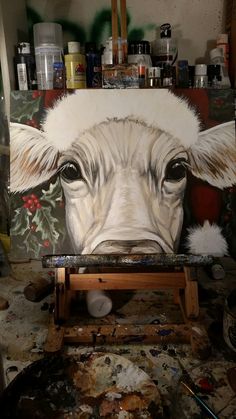 a painting of a cow's face is being worked on