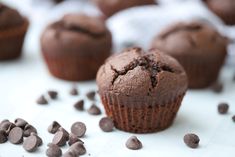 chocolate muffins with chocolate chips scattered around them