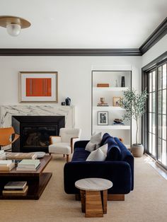 a living room filled with furniture and a fire place in the middle of a room