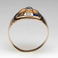 This distinguished mens 10K yellow gold Fraternal Order of Eagles ring features an eagle design and enameled accents. The eagle's chest is bead set with a round brilliant cut diamond. The ring measures 14.4mm wide with a 4.4mm rise above the finger at the top, tapering to 3.0mm wide and 0.5mm thick at the bottom of the shank. The ring is currently a size 11.5 and we offer complimentary sizing to fit. Fraternal Order Of Eagles, Eagle Design, An Eagle, Rise Above, Bead Set, July Birthstone, Ruby Ring, Round Brilliant Cut Diamond, High Quality Jewelry