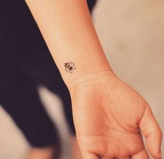 a person with a small tattoo on their wrist