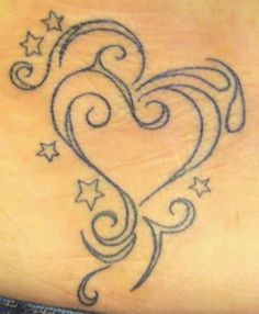 a heart tattoo with stars on it