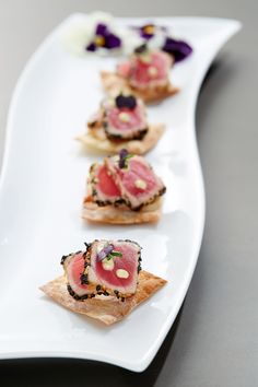 small appetizers are arranged on a white plate