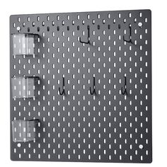 a metal peg board with three cups on it