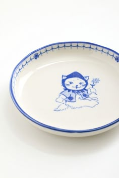 a blue and white plate with a cat on it