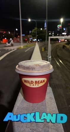 a red cup sitting on the side of a road