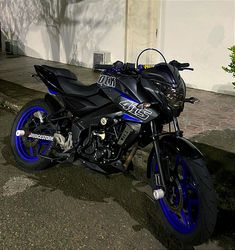 a blue and black motorcycle parked on the street