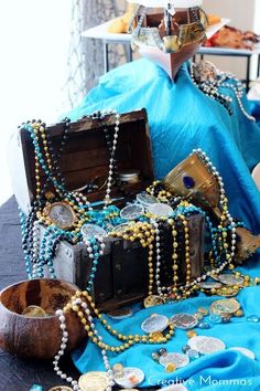 a table topped with lots of different types of beads and other items on top of it