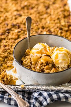 a bowl filled with ice cream sitting on top of a pan covered in granola