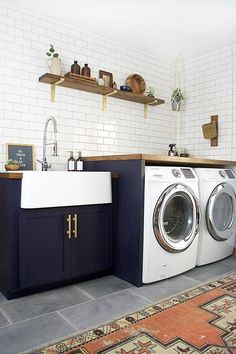 a washer and dryer in a room with white bricks on the wall behind them