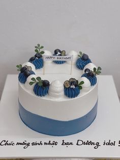 a birthday cake with blue and white decorations