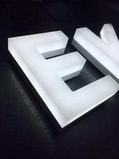 the letters e and f are made out of white acrylic paint on a black surface