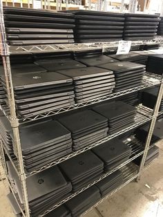 several stacks of black plastic boxes on shelves