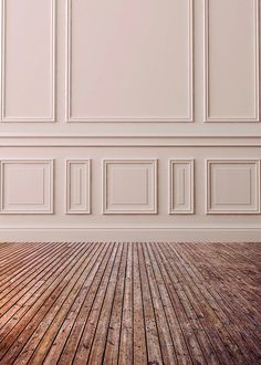 an empty room with white walls and wooden floors