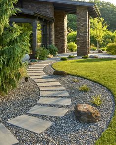 a stone path in the middle of a garden with rocks and grass around it, leading to a covered patio