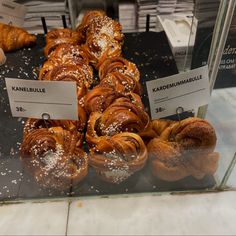 some croissants and other pastries are on display