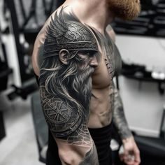 a man with a viking tattoo on his arm