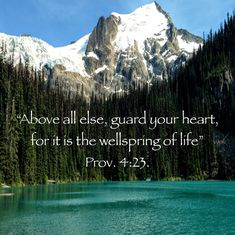 a lake with mountains in the background and a bible verse written on it's side