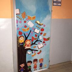 an open door with children's drawings on it and books falling off the tree