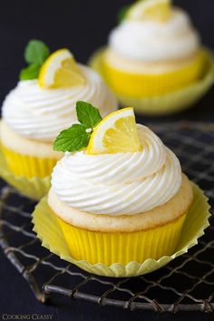 three cupcakes with lemon and whipped cream frosting