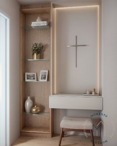 a small white bathroom with a cross on the wall and shelves in front of it