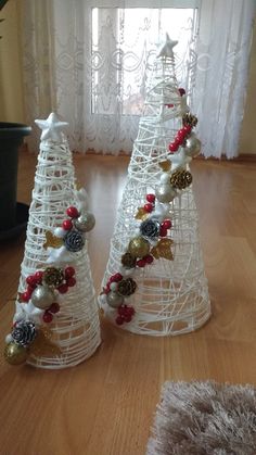 two white wire christmas trees decorated with ornaments