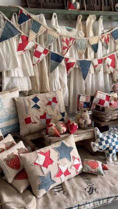 many pillows and cushions are on display in a room filled with old fashioned decor items