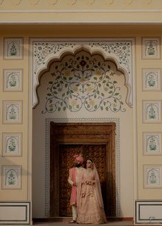 two people standing in front of a doorway