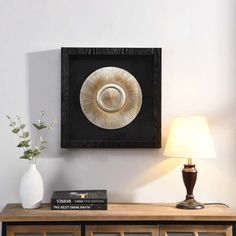 a white vase sitting on top of a wooden dresser