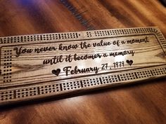 a wooden plaque with the words, you're never ending the value of a moment until it becomes a memory