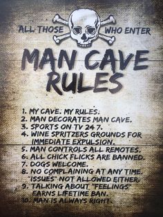 a sign that says man cave rules on the side of a building with skull and crossbones