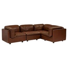 a brown leather sectional sofa with two recliners on the back and one arm facing each other