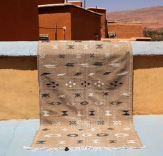 a brown and white rug sitting on top of a roof